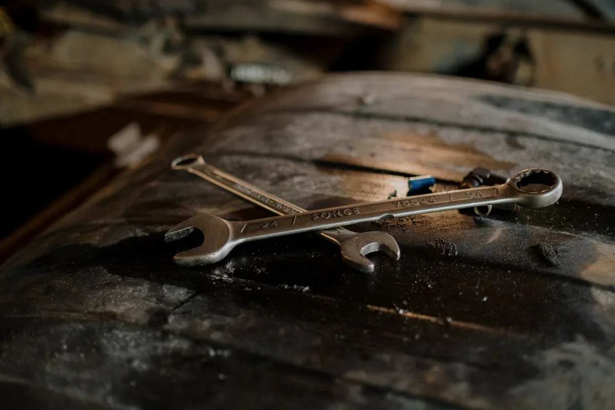 Wrenches on a textured surface in a workshop