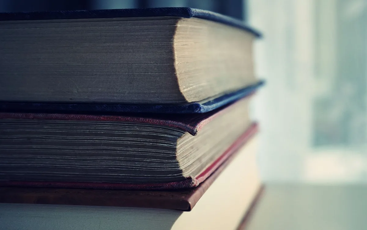 Stacked vintage books with soft focus on pages
