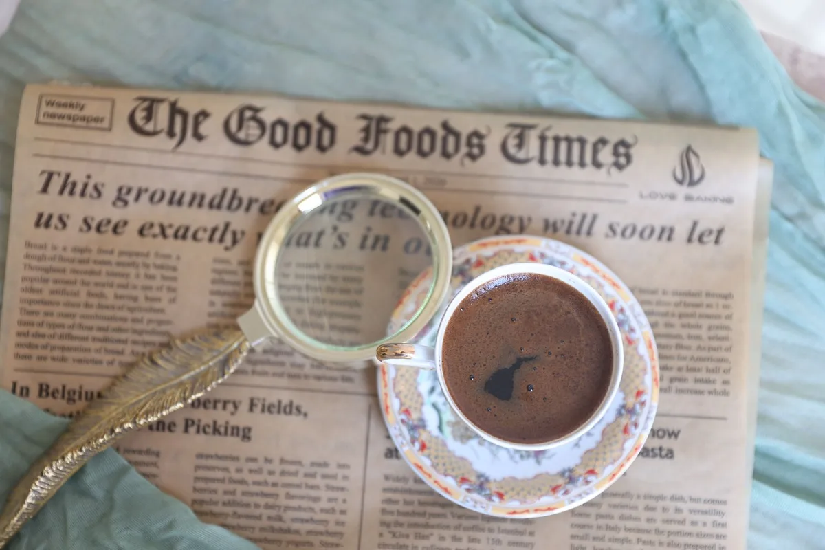 Vintage setup with coffee, magnifying glass and newspaper